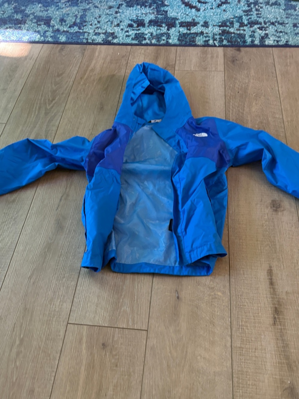 The North Face Youth Medium Blue Hooded Rain Jacket with Navy Accents